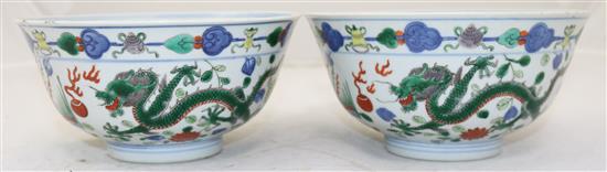 A pair of Chinese wucai dragon and phoenix bowls, Qianlong seal marks, late 19th/early 20th century, 18cm, small rim chips